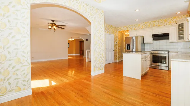 an empty room with a window and a fan