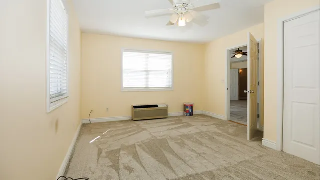 a spacious bedroom with a bed and a window