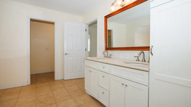 a view of an empty room with windows and closet