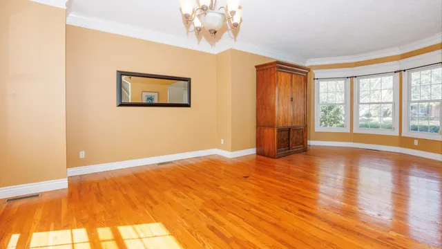 a view of empty room with wooden floor and fireplace