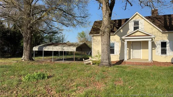 a front view of a house with a yard