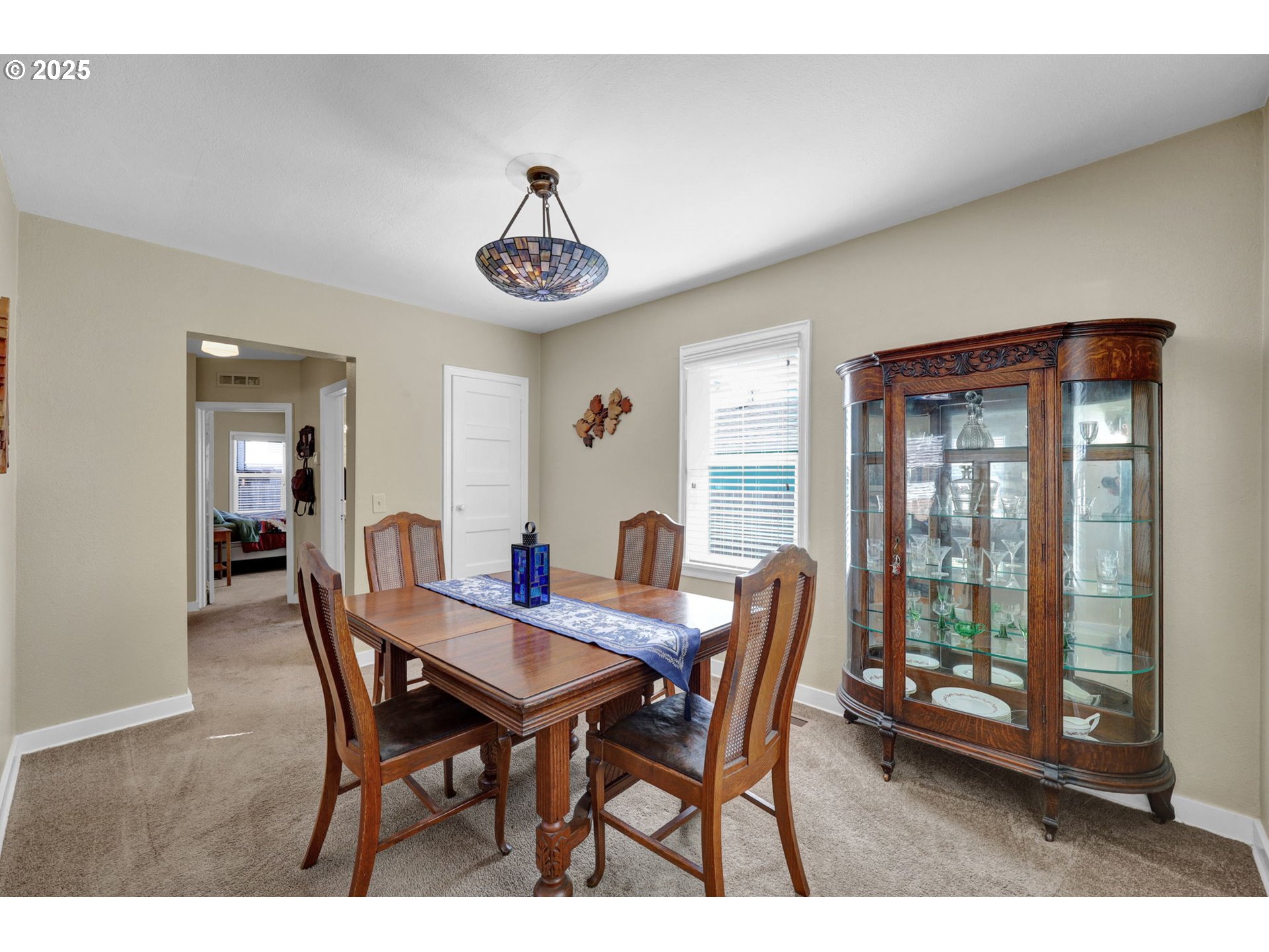 1441 6th Street Springfield, OR 97477 - Photo 11 of 48 a view of a dining room with furniture wooden floor and a chandelier