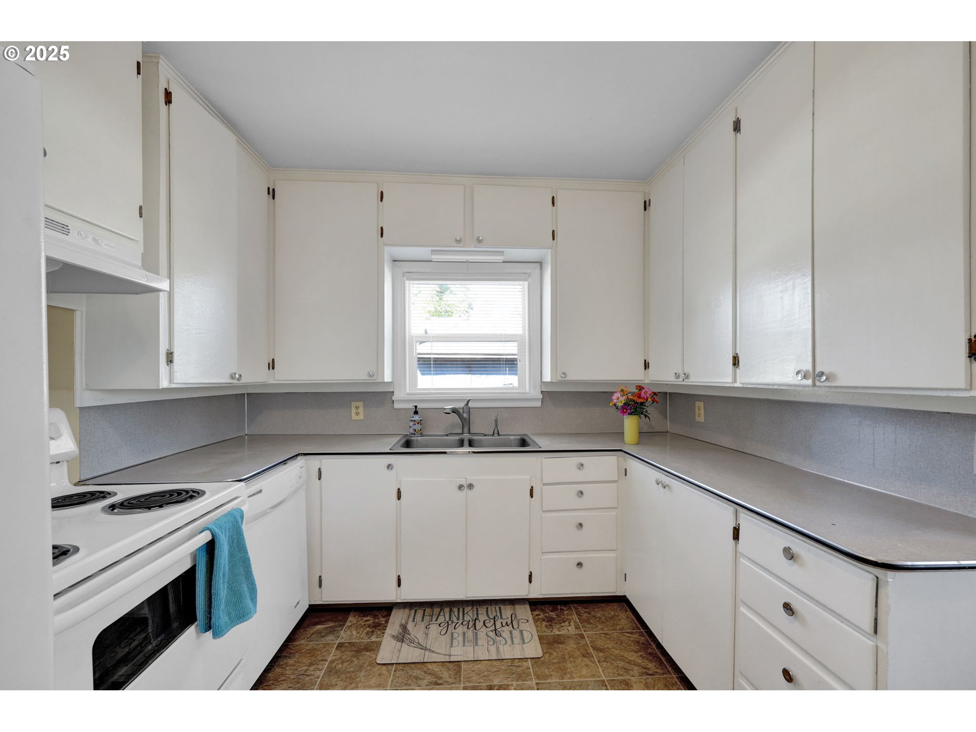 1441 6th Street Springfield, OR 97477 - Photo 14 of 48 a kitchen with granite countertop white cabinets and white appliances