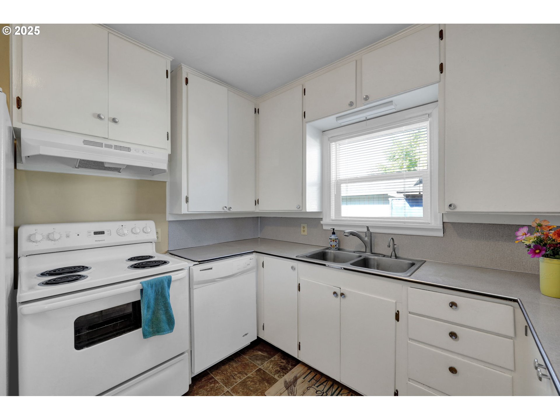 1441 6th Street Springfield, OR 97477 - Photo 15 of 48 a kitchen with cabinets appliances a sink and a window