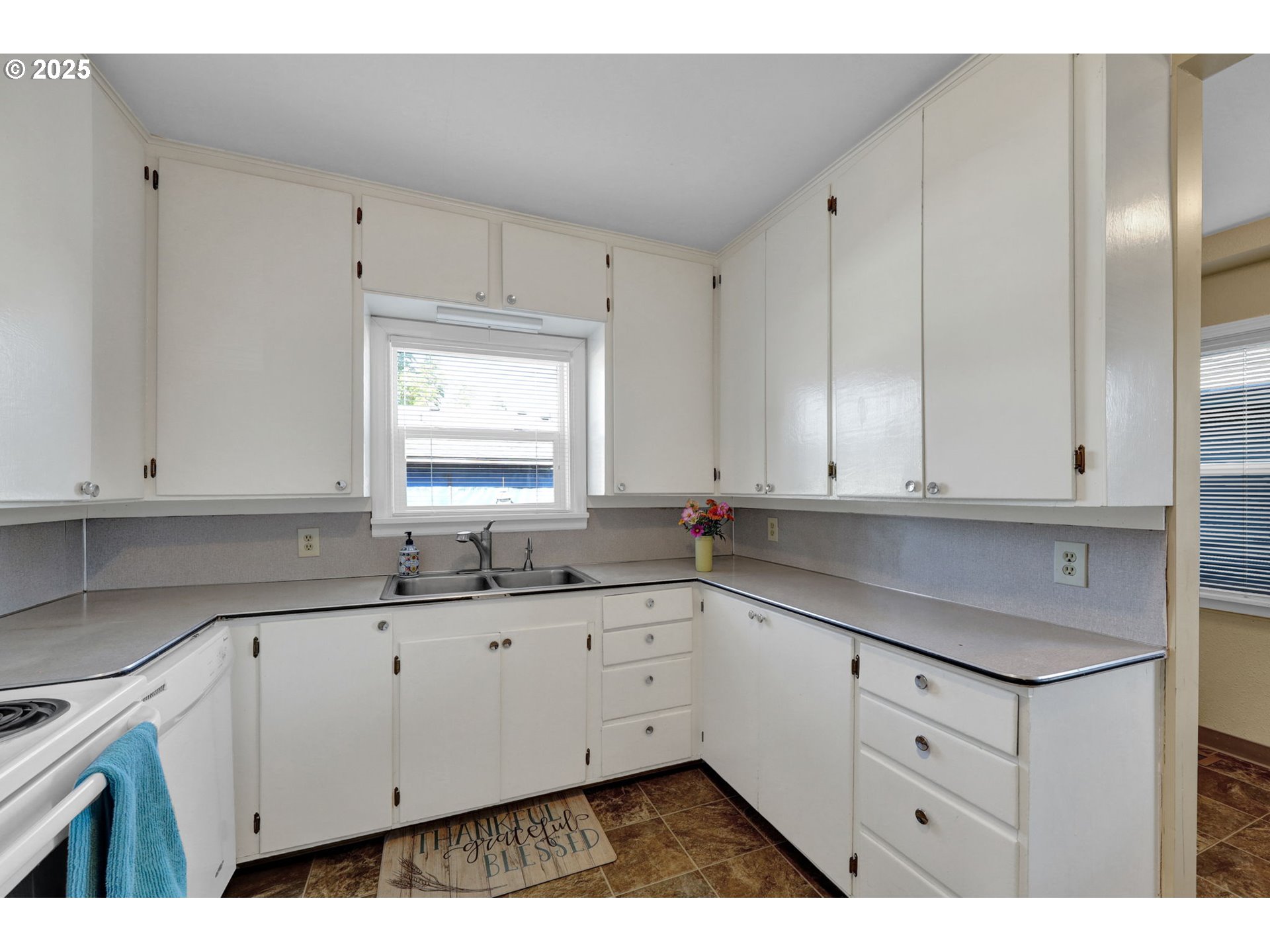 1441 6th Street Springfield, OR 97477 - Photo 16 of 48 a kitchen with granite countertop white cabinets white stainless steel appliances and sink