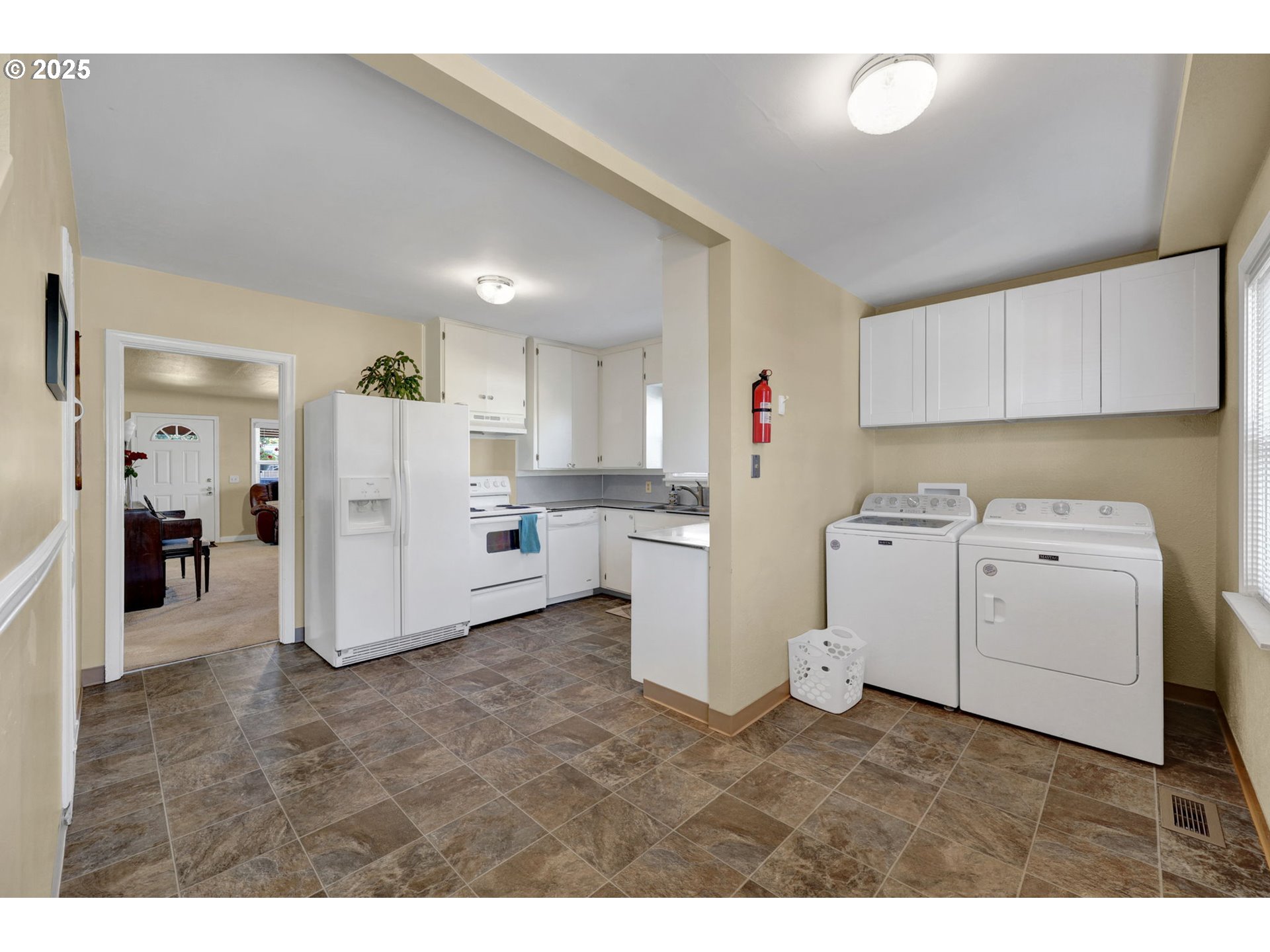 1441 6th Street Springfield, OR 97477 - Photo 17 of 48 a view of a kitchen with refrigerator and white cabinets