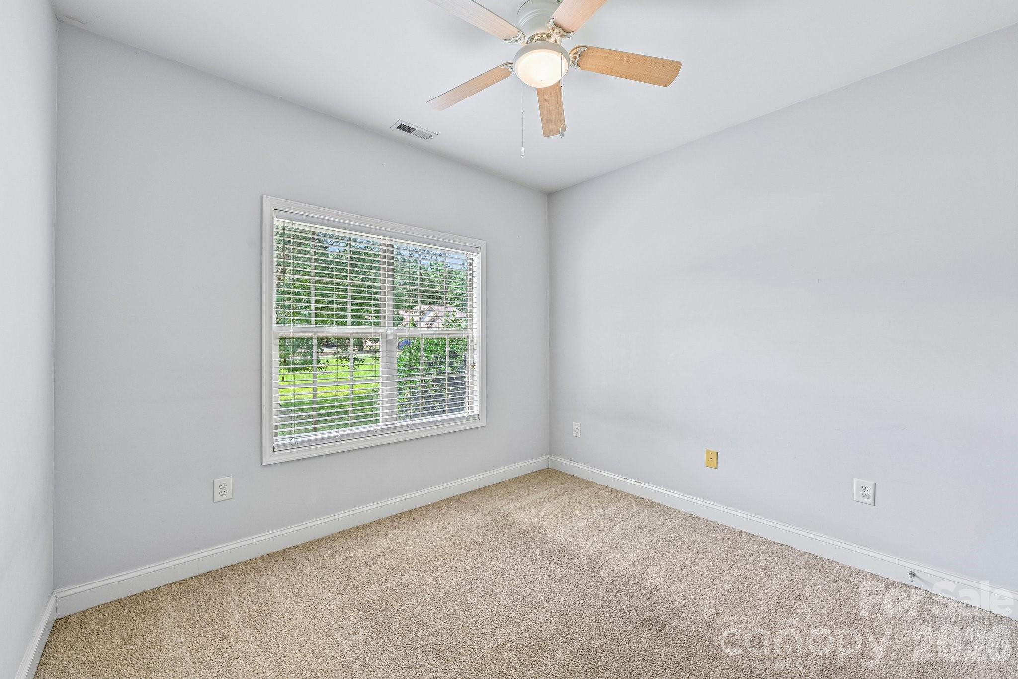 624 Hunley Street Monroe, NC 28112 - Photo 16 of 36 an empty room with a window and a fan
