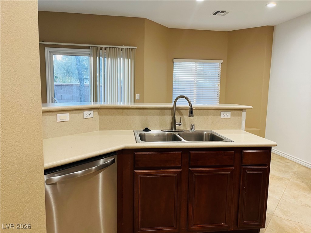 259 Integrity Ridge Drive Henderson, NV 89052 - Photo 12 of 50 Kitchen w/breakfast bar w/corian counters, cherry cabinets, SS appliances, tile floors, new sink & faucet, dining nook & pantry.