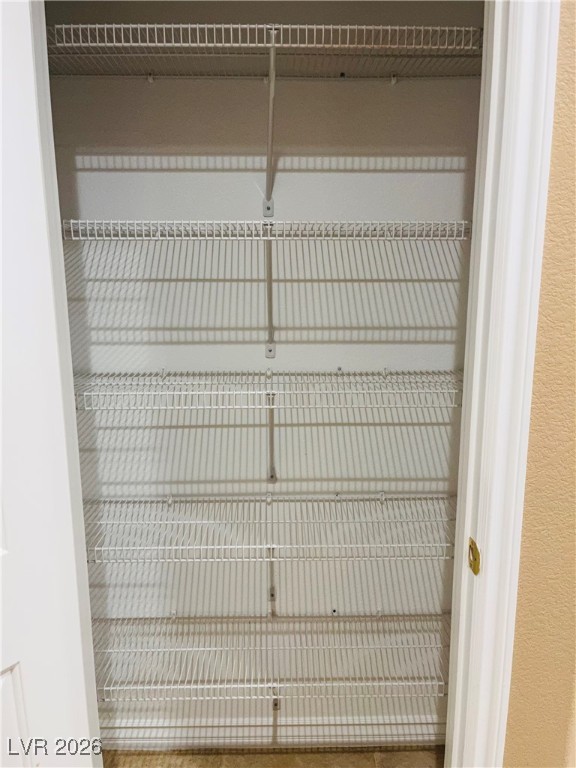 259 Integrity Ridge Drive Henderson, NV 89052 - Photo 13 of 50 Kitchen w/breakfast bar w/corian counters, cherry cabinets, SS appliances, tile floors, new sink & faucet, dining nook & pantry.