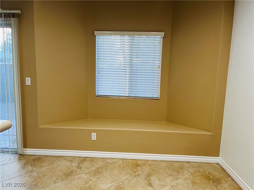 259 Integrity Ridge Drive Henderson, NV 89052 - Photo 16 of 50 Kitchen w/breakfast bar w/corian counters, cherry cabinets, SS appliances, tile floors, new sink & faucet, dining nook & pantry.