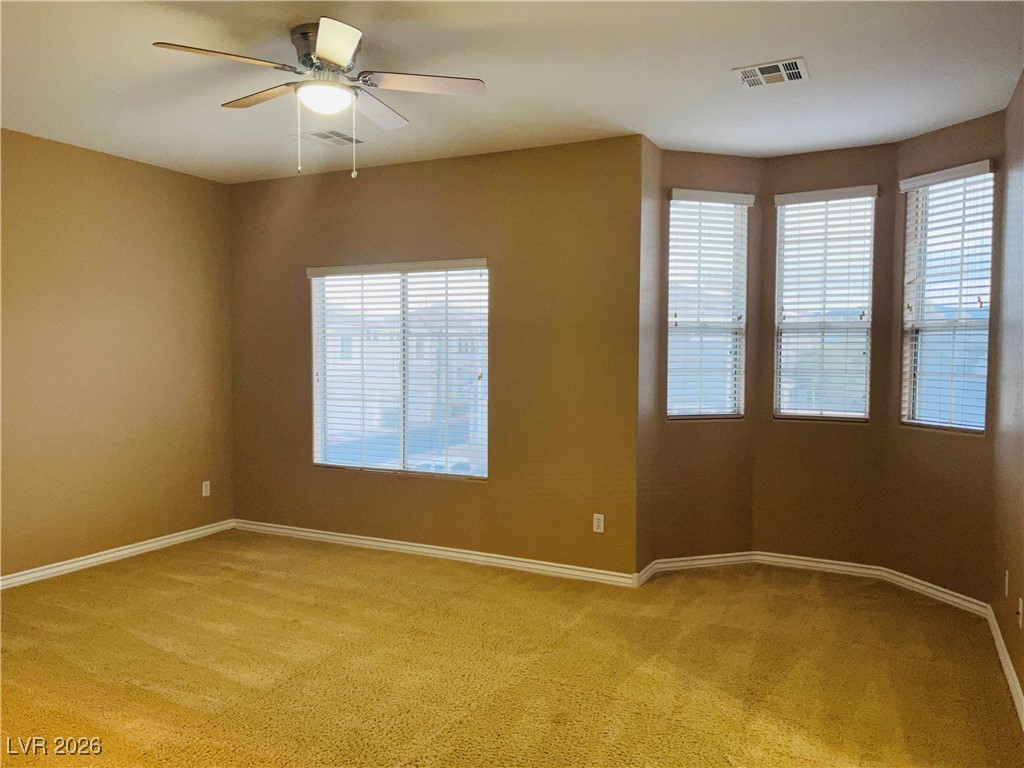259 Integrity Ridge Drive Henderson, NV 89052 - Photo 17 of 50 Primary bed w/ceiling fan & light, carpet & walk in closet.