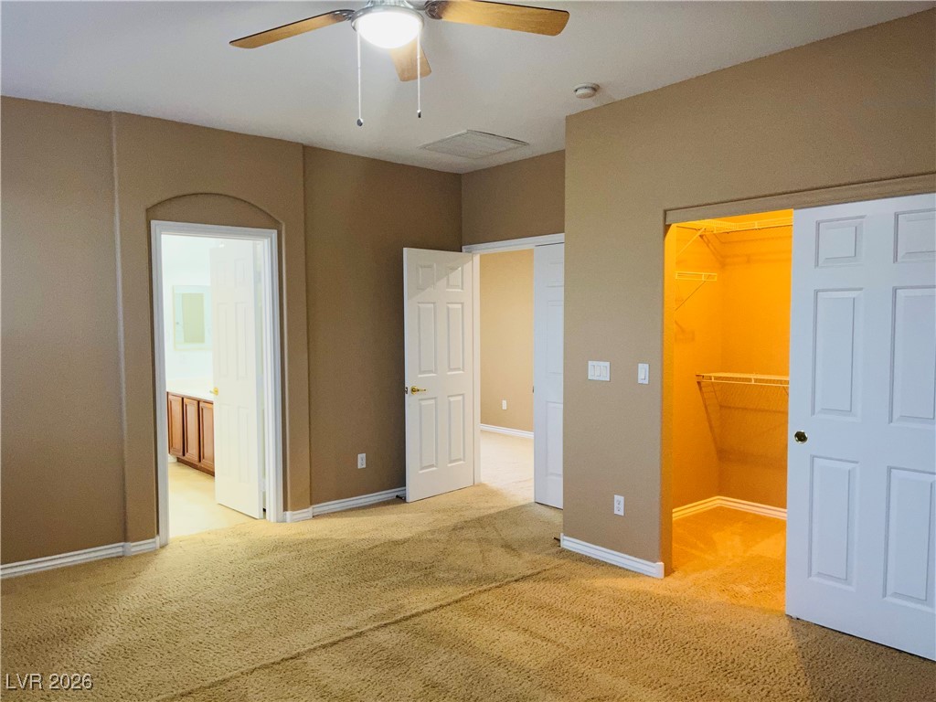 259 Integrity Ridge Drive Henderson, NV 89052 - Photo 19 of 50 Primary bed w/ceiling fan & light, carpet & walk in closet.