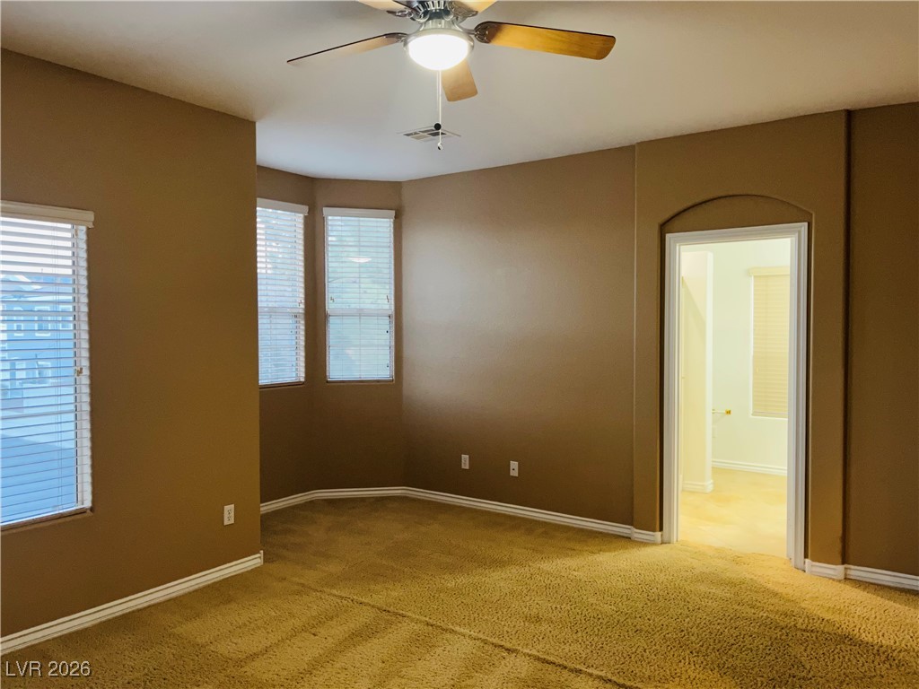 259 Integrity Ridge Drive Henderson, NV 89052 - Photo 20 of 50 Primary bed w/ceiling fan & light, carpet & walk in closet.