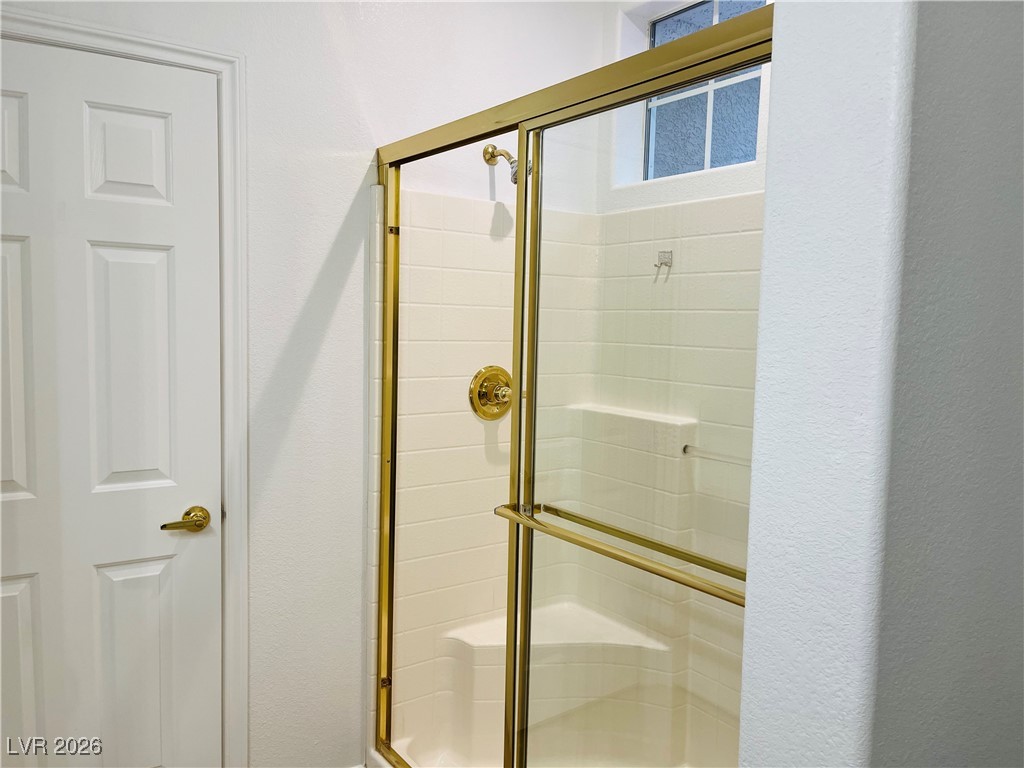 259 Integrity Ridge Drive Henderson, NV 89052 - Photo 25 of 50 Primary bath w/dual sinks, shower, cherry cabinets, corian counters w/new faucets & tile floors.