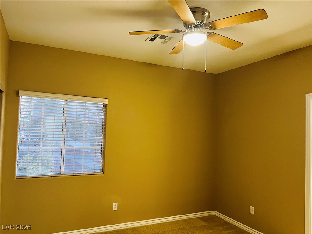 259 Integrity Ridge Drive Henderson, NV 89052 - Photo 31 of 50 Bed 2 w/ceiling fan & light, carpet that share jack-n-jill bath w/dual sinks, cherry cabinets, corian counters w/new faucets w/tub & shower combo.