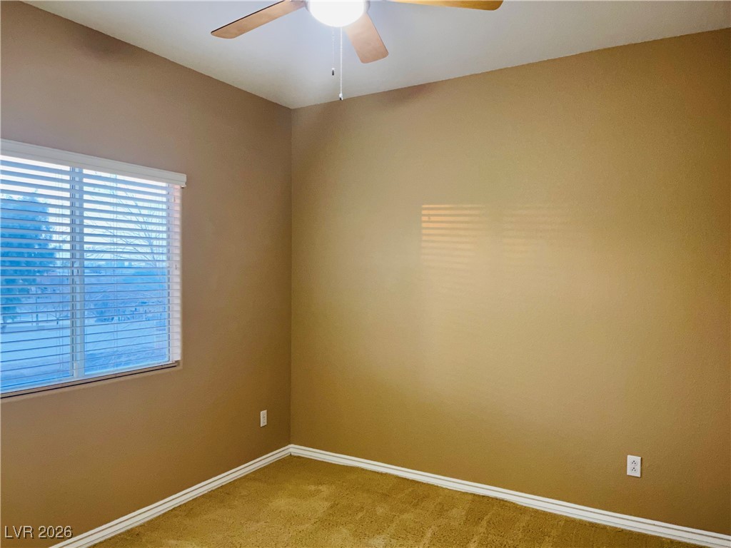 259 Integrity Ridge Drive Henderson, NV 89052 - Photo 33 of 50 Bed 2 w/ceiling fan & light, carpet that share jack-n-jill bath w/dual sinks, cherry cabinets, corian counters w/new faucets w/tub & shower combo.