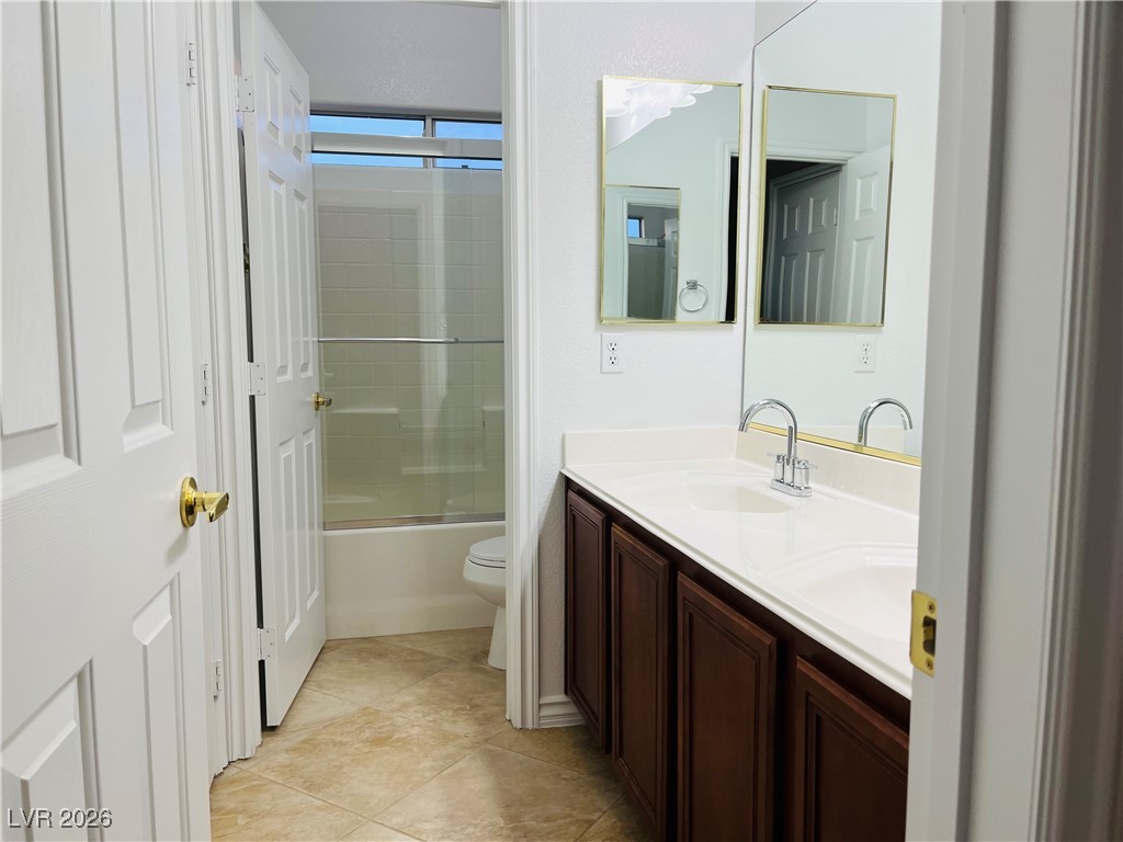 259 Integrity Ridge Drive Henderson, NV 89052 - Photo 38 of 50 Jack-n-jill bath w/dual sinks, cherry cabinets, corian counters w/new faucets w/tub & shower combo.