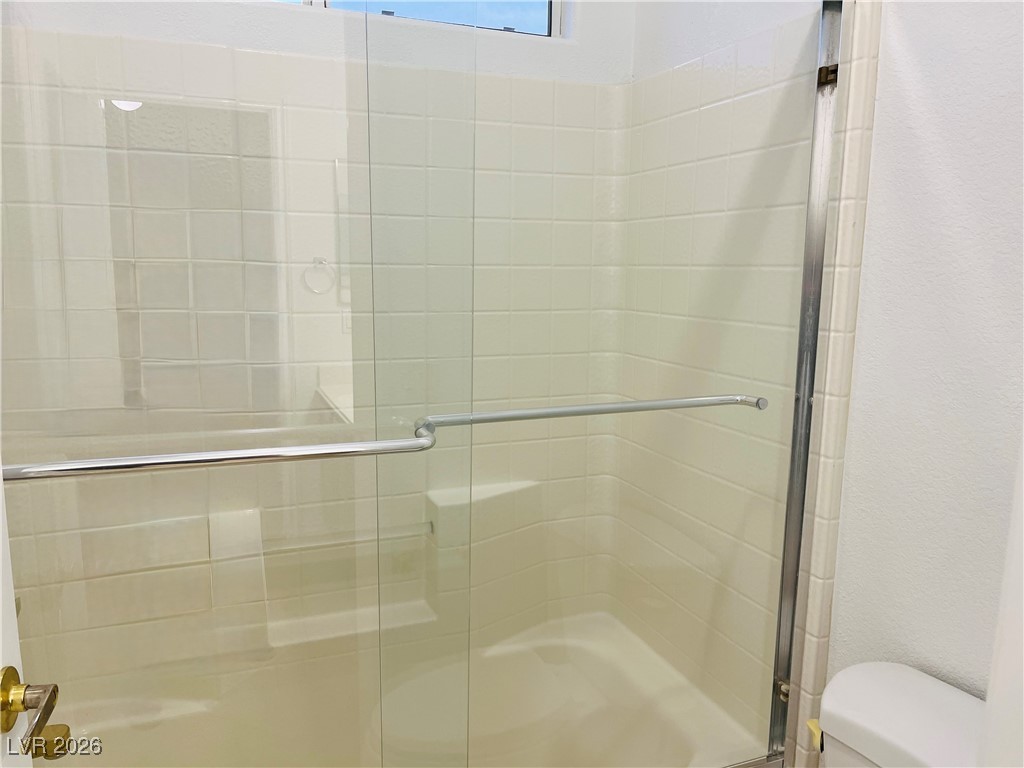 259 Integrity Ridge Drive Henderson, NV 89052 - Photo 40 of 50 Jack-n-jill bath w/dual sinks, cherry cabinets, corian counters w/new faucets w/tub & shower combo.