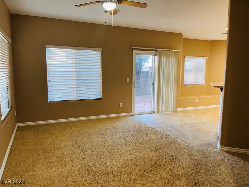 259 Integrity Ridge Drive Henderson, NV 89052 - Photo 5 of 50 Living w/ceiling fan & light, carpet & open to kitchen & dining.