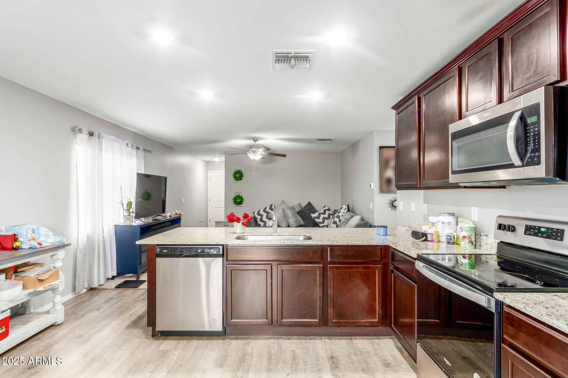 685 West 16th Street Florence, AZ 85132 - Photo 9 of 26 a kitchen with stainless steel appliances a sink stove and cabinets