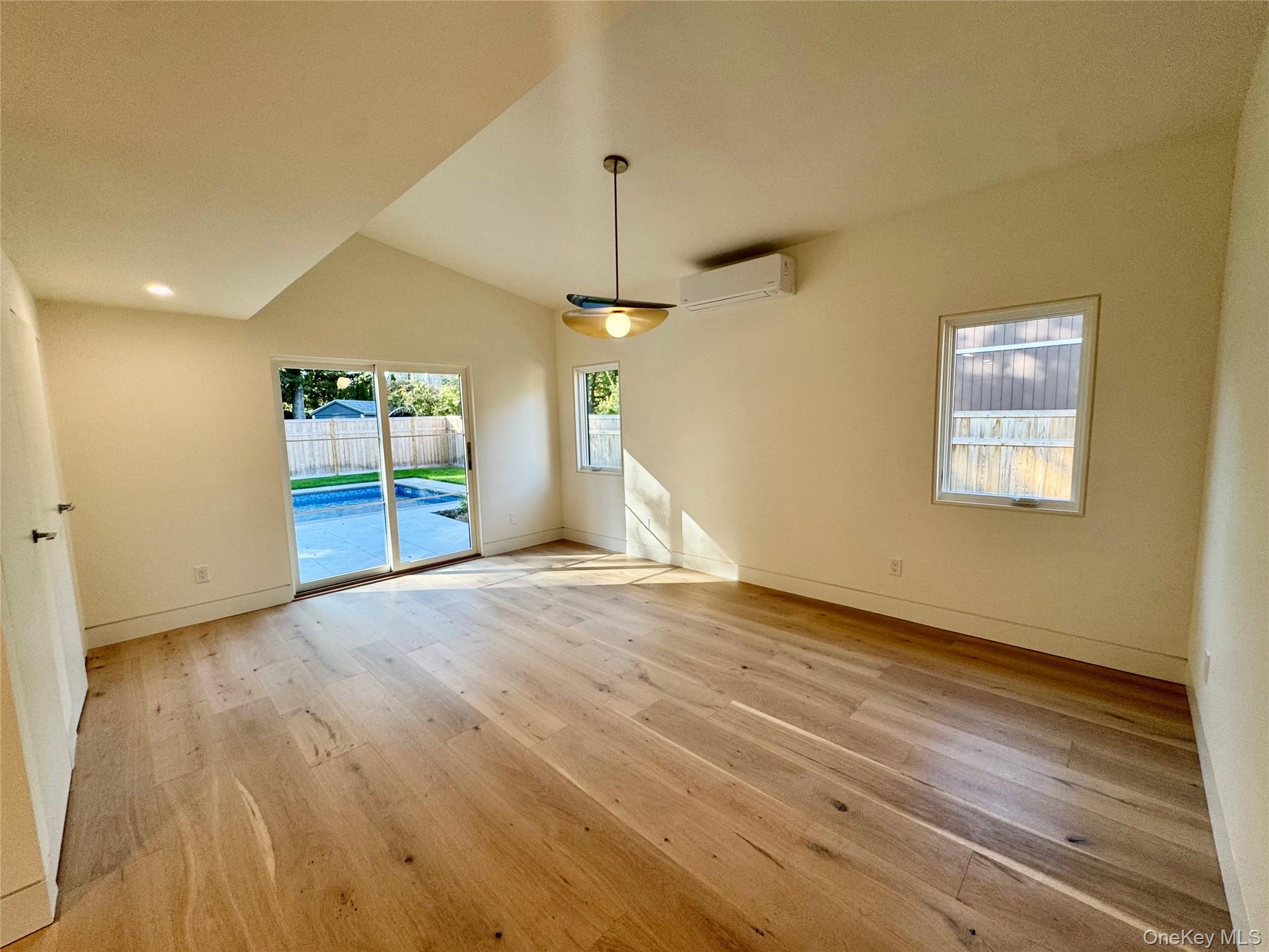 17 Heather Drive Remsenburg, NY 11960 - Photo 18 of 37 an empty room with wooden floor and windows