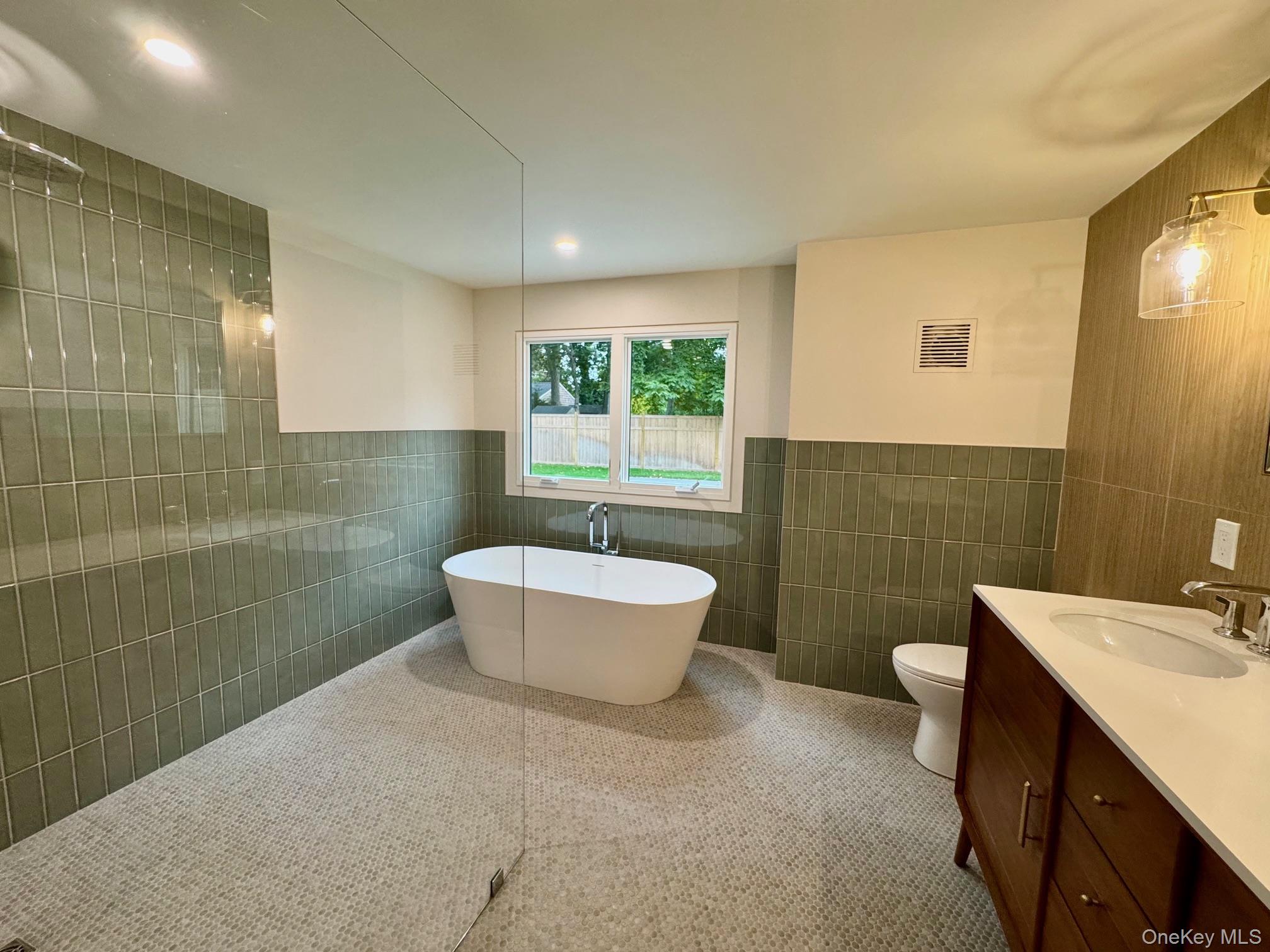 17 Heather Drive Remsenburg, NY 11960 - Photo 21 of 37 a bathroom with a sink mirror toilet and bathtub