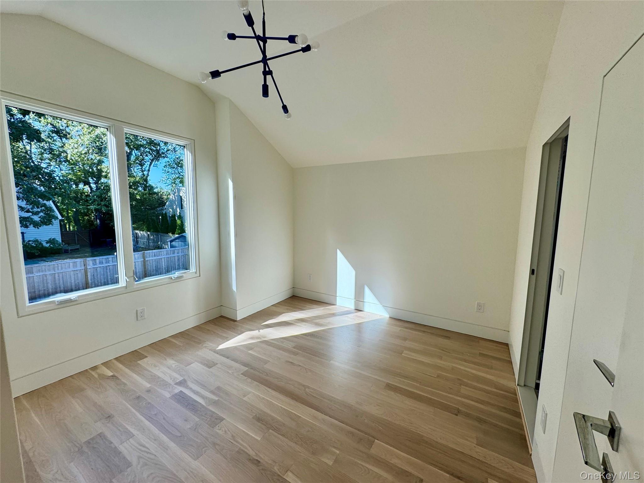 17 Heather Drive Remsenburg, NY 11960 - Photo 24 of 37 a view of an empty room with wooden floor and a window