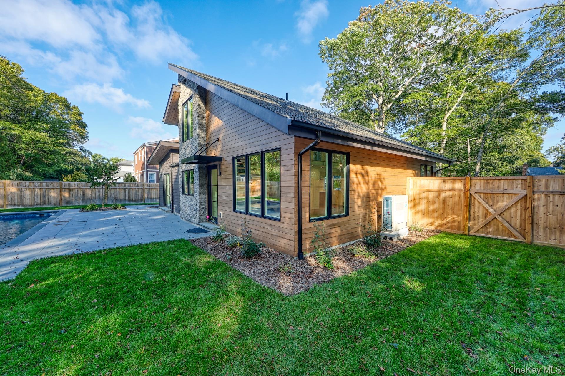 17 Heather Drive Remsenburg, NY 11960 - Photo 32 of 37 a view of a small house with a small yard and a garden