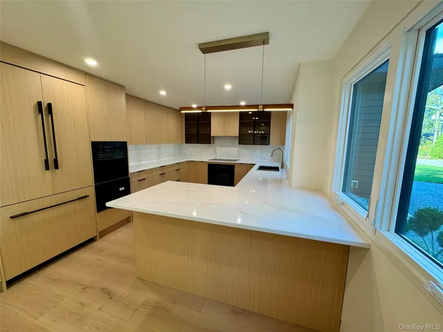 a kitchen with stainless steel appliances a refrigerator sink and stove