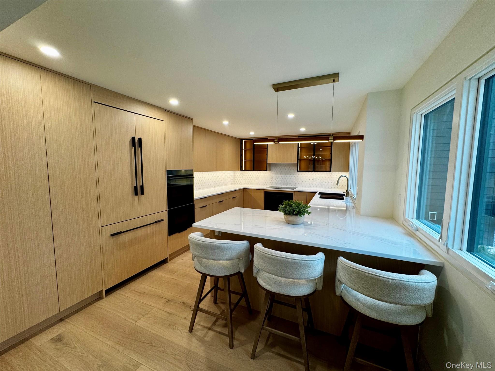 17 Heather Drive Remsenburg, NY 11960 - Photo 5 of 37 a kitchen with a table chairs refrigerator and cabinets