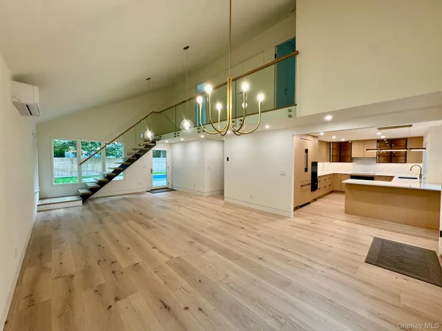 a view of empty room with wooden floor and window