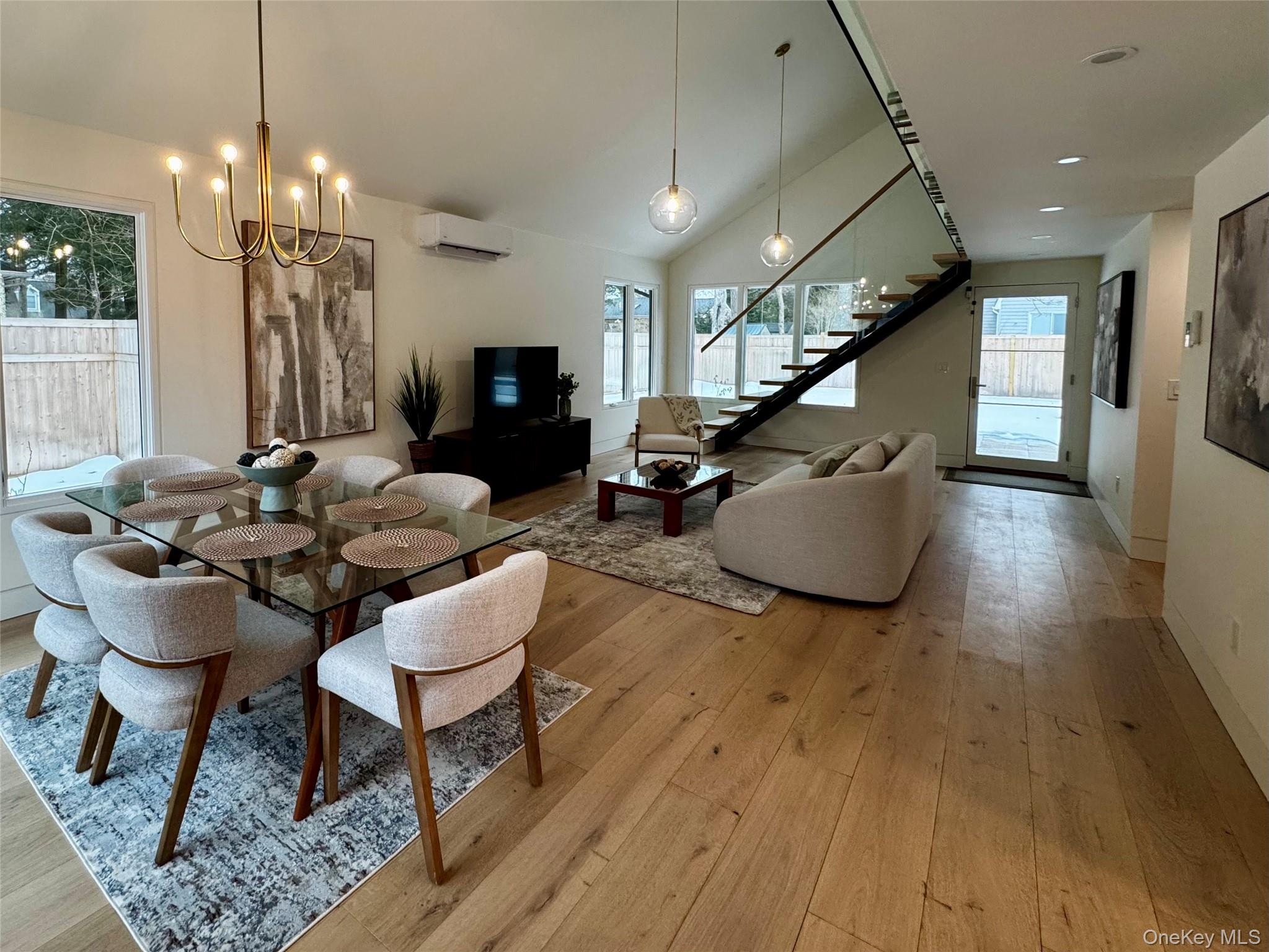 17 Heather Drive Remsenburg, NY 11960 - Photo 9 of 37 a living room with furniture and a chandelier