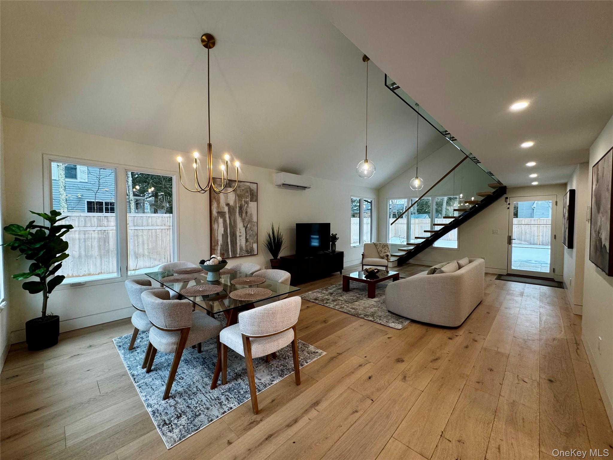 17 Heather Drive Remsenburg, NY 11960 - Photo 10 of 37 a living room with furniture and a chandelier