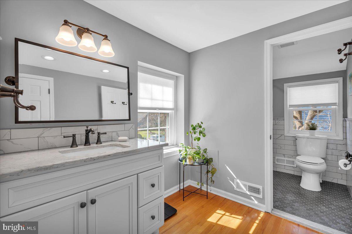 126 Ashford Road Cherry Hill, NJ 08003 - Photo 21 of 43 a bathroom with a granite countertop sink vanity mirror and toilet