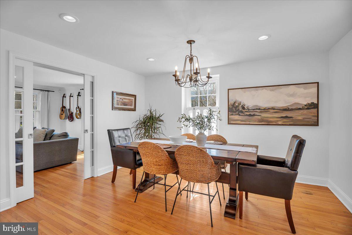 126 Ashford Road Cherry Hill, NJ 08003 - Photo 9 of 43 a view of a dining room with furniture a chandelier and wooden floor