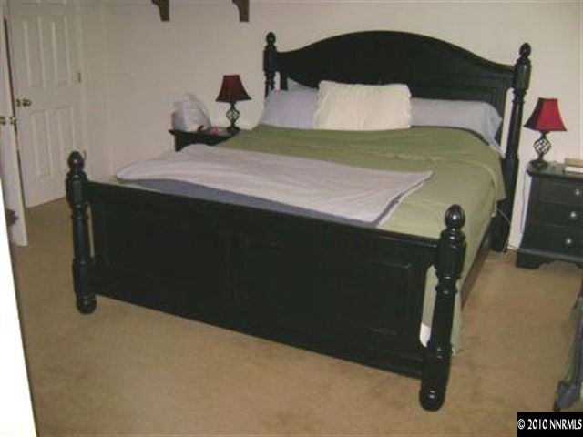 10211 Wolf Ridge Way Reno, NV 89521 - Photo 3 of 4 a bedroom with a bed and teddy bear