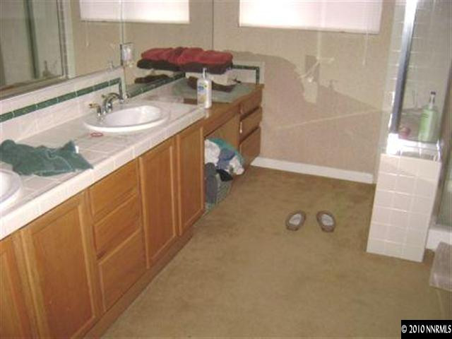 10211 Wolf Ridge Way Reno, NV 89521 - Photo 4 of 4 a bathroom with a sink and a mirror
