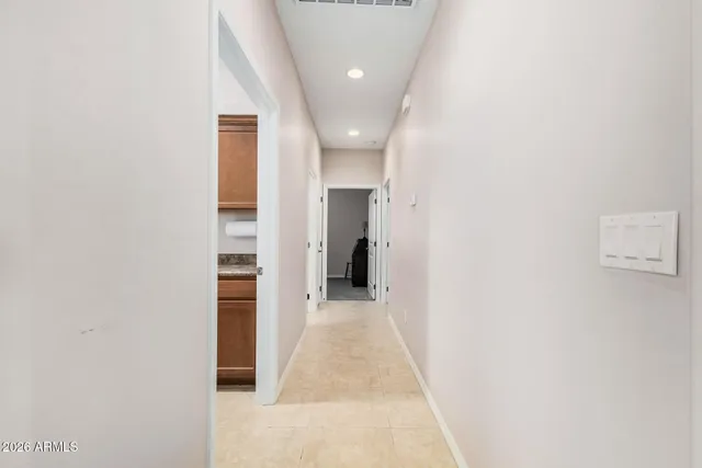 a kitchen with granite countertop white cabinets and sink