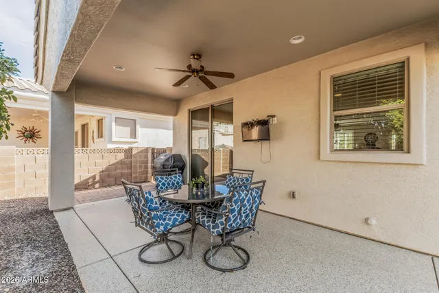 a dining room with furniture and a potted plant