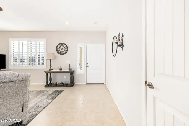 a living room with furniture a clock and a window