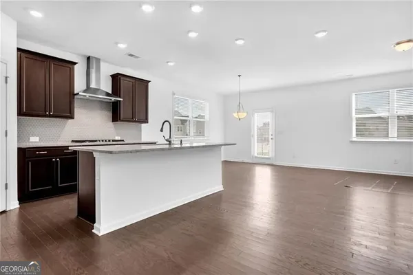 a kitchen with stainless steel appliances a refrigerator and a stove top oven