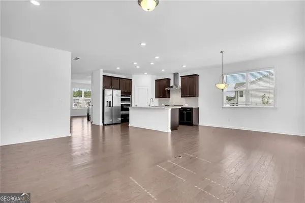 a view of kitchen with furniture and wooden floor