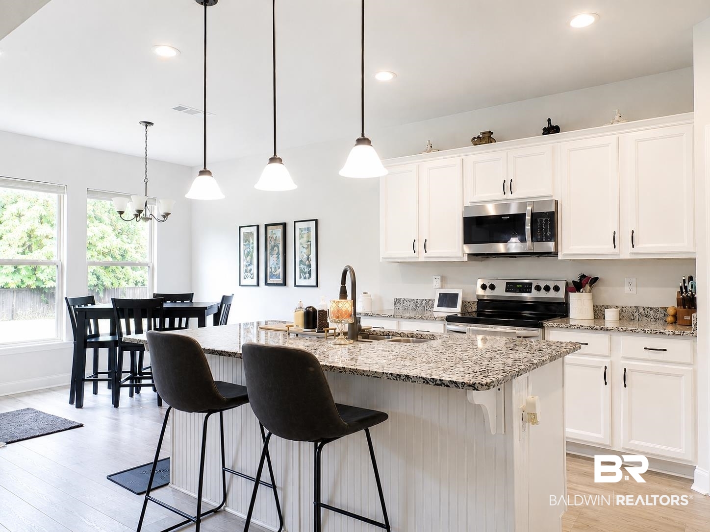 1097 Stella Road Foley, AL 36535 - Photo 6 of 15 Open-concept kitchen featuring white cabinetry, granite countertops, stainless steel appliances, a center island with pendant lighting, and wood-finish flooring