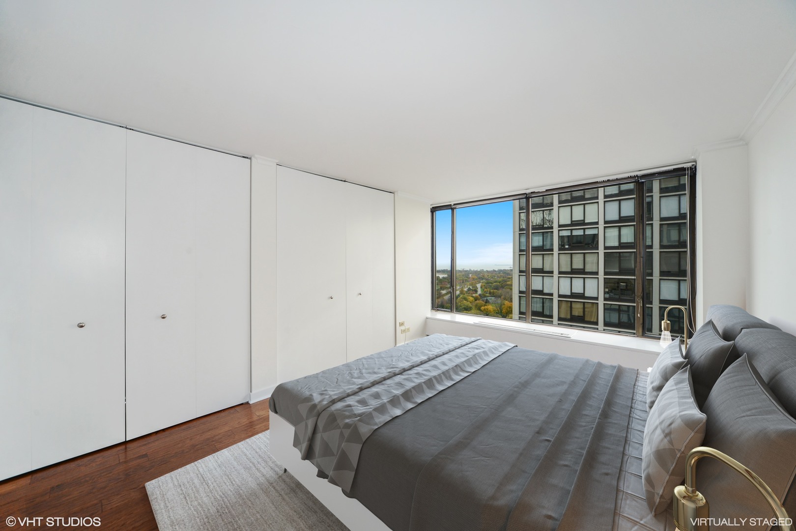 5455 North Sheridan Road, Unit 2810 Chicago, IL 60640 - Photo 5 of 9 a spacious bedroom with a bed and a large window