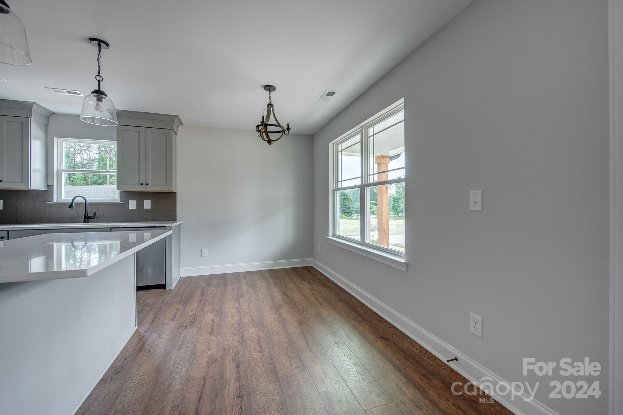 525 Blacksnake Road Stanley, NC 28164 - Photo 12 of 21 a kitchen with granite countertop a sink cabinets and wooden floor