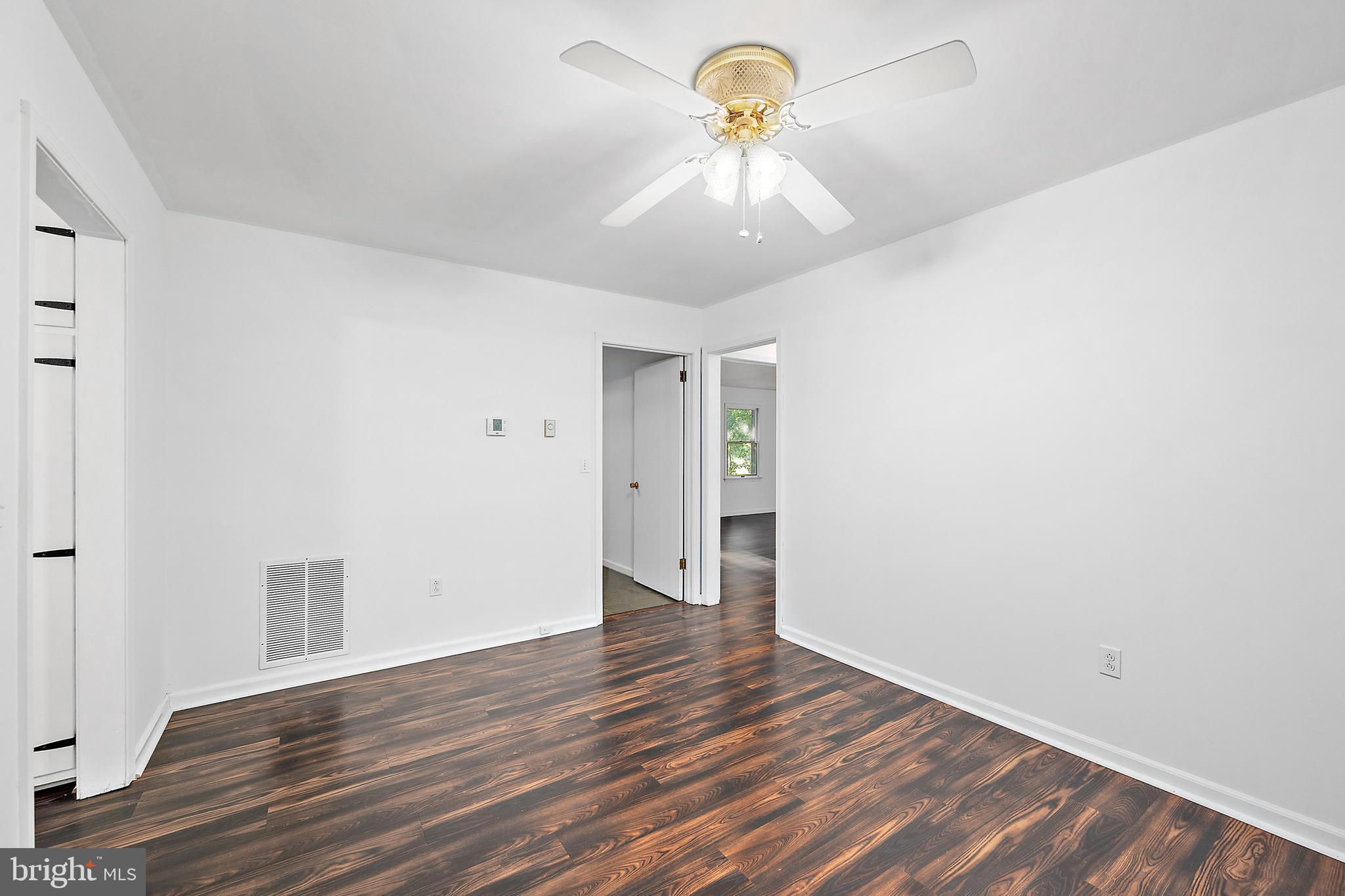 6181 Rockawalkin Road Salisbury, MD 21801 - Photo 22 of 65 a view of an empty room with a window and wooden floor