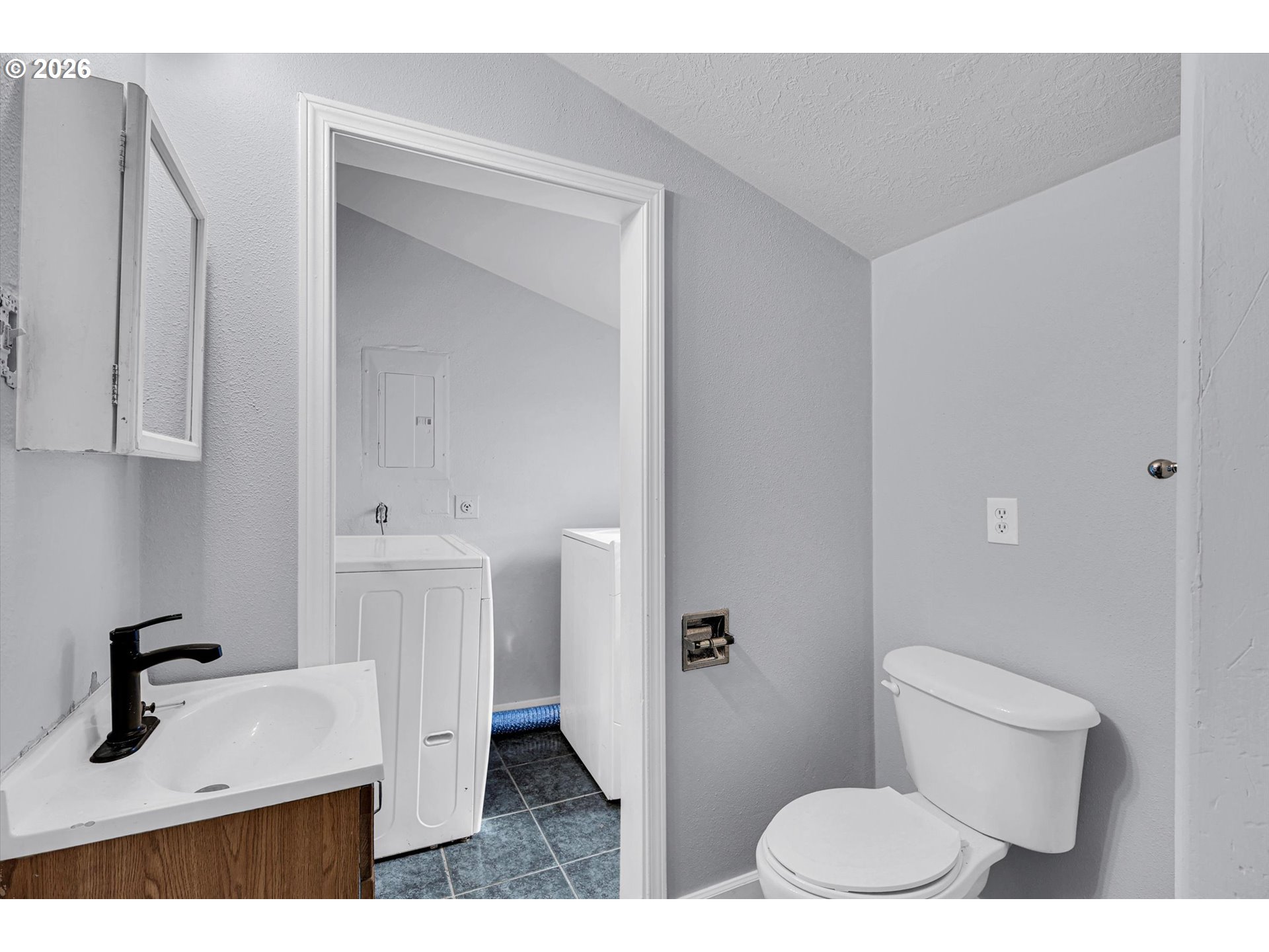 14125 Southeast Division Street Portland, OR 97233 - Photo 15 of 17 a bathroom with a sink toilet and vanity