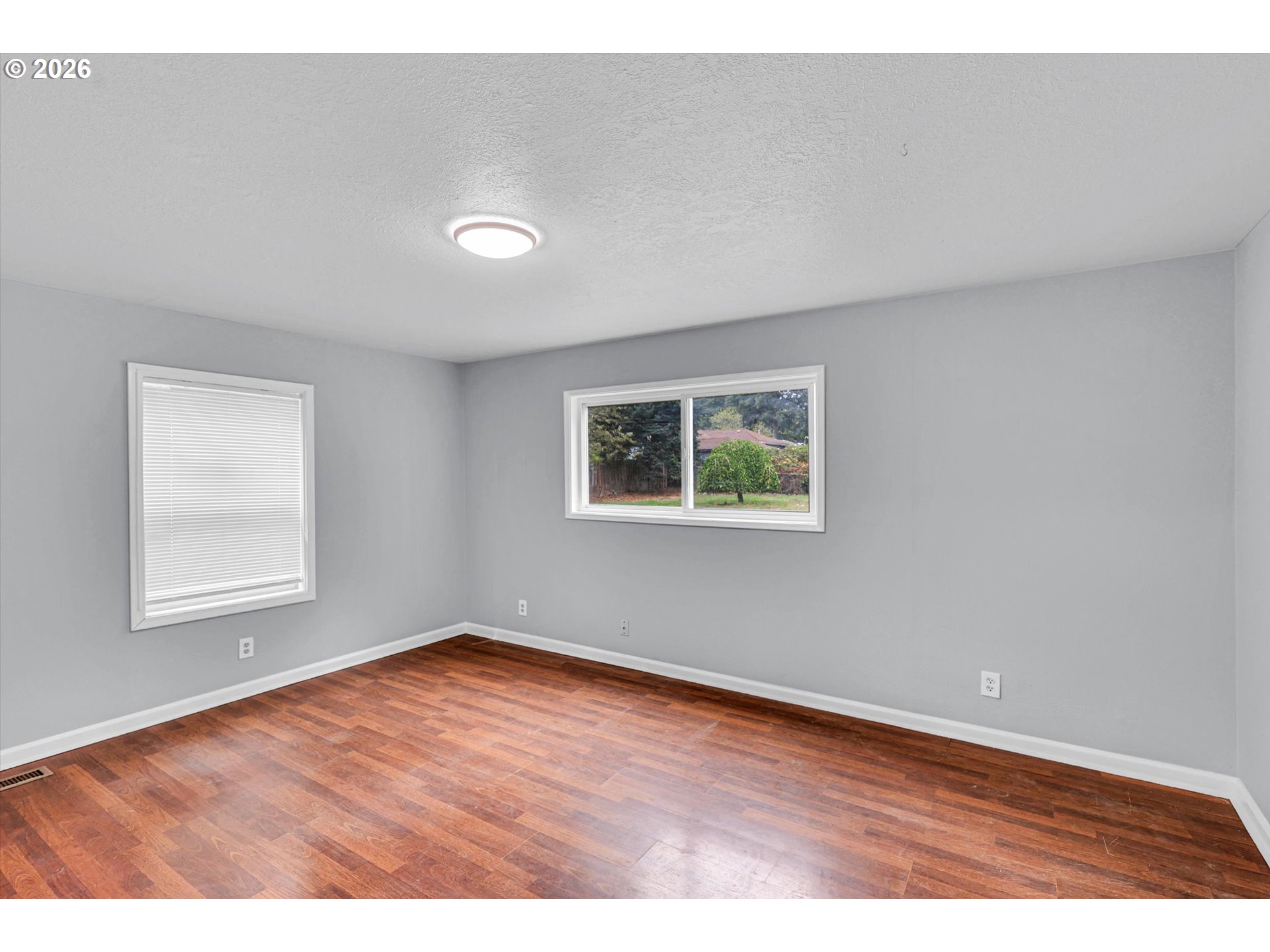 14125 Southeast Division Street Portland, OR 97233 - Photo 16 of 17 an empty room with wooden floor and windows