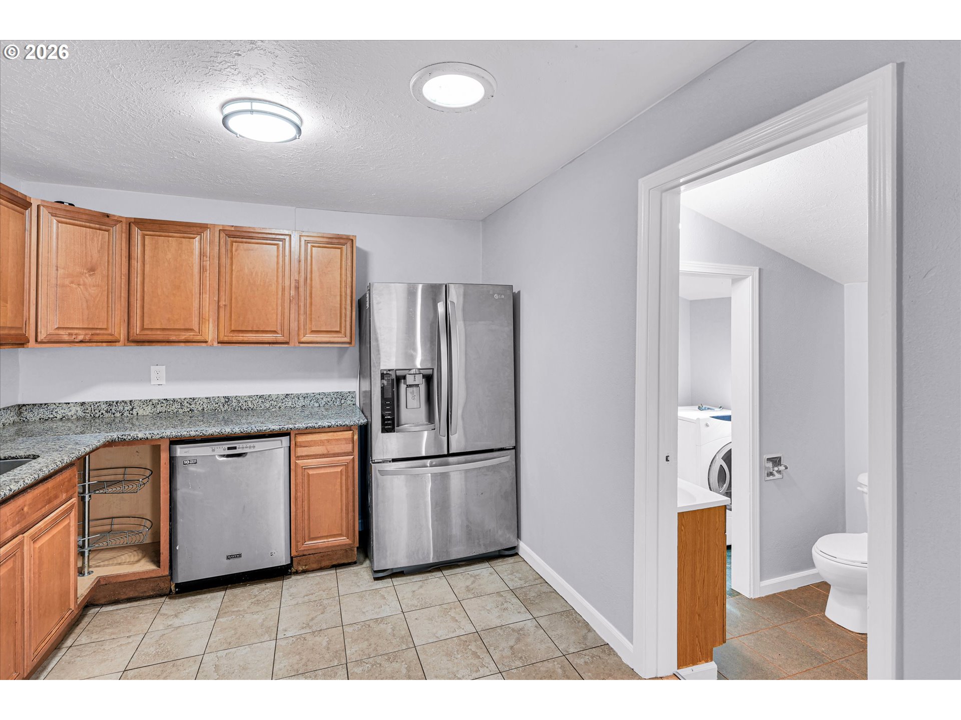 14125 Southeast Division Street Portland, OR 97233 - Photo 7 of 17 a open kitchen with granite countertop a refrigerator and a sink