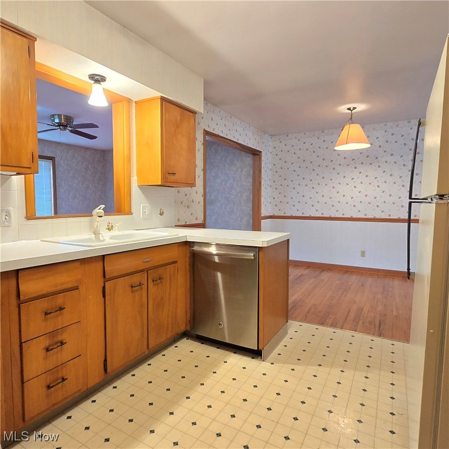 2317 Liberty Road Stow, OH 44224 - Photo 8 of 29 Kitchen featuring light countertops, stainless steel dishwasher and original mid century cabinetry and Peninsula.